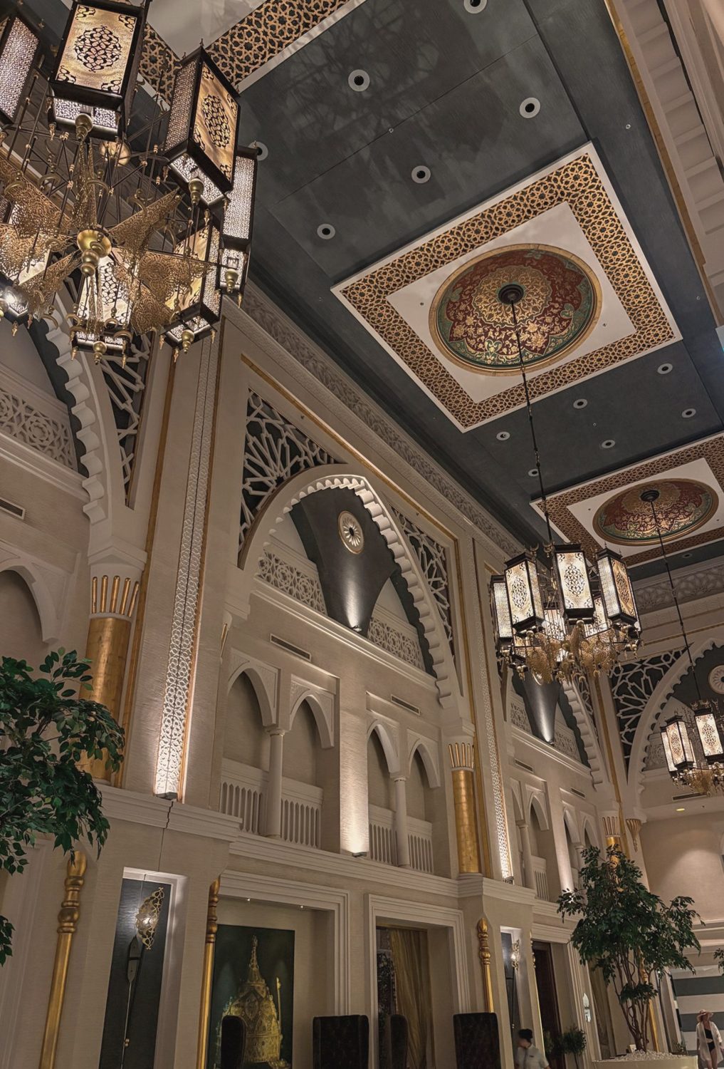 An arched hall lit by warm lanterns