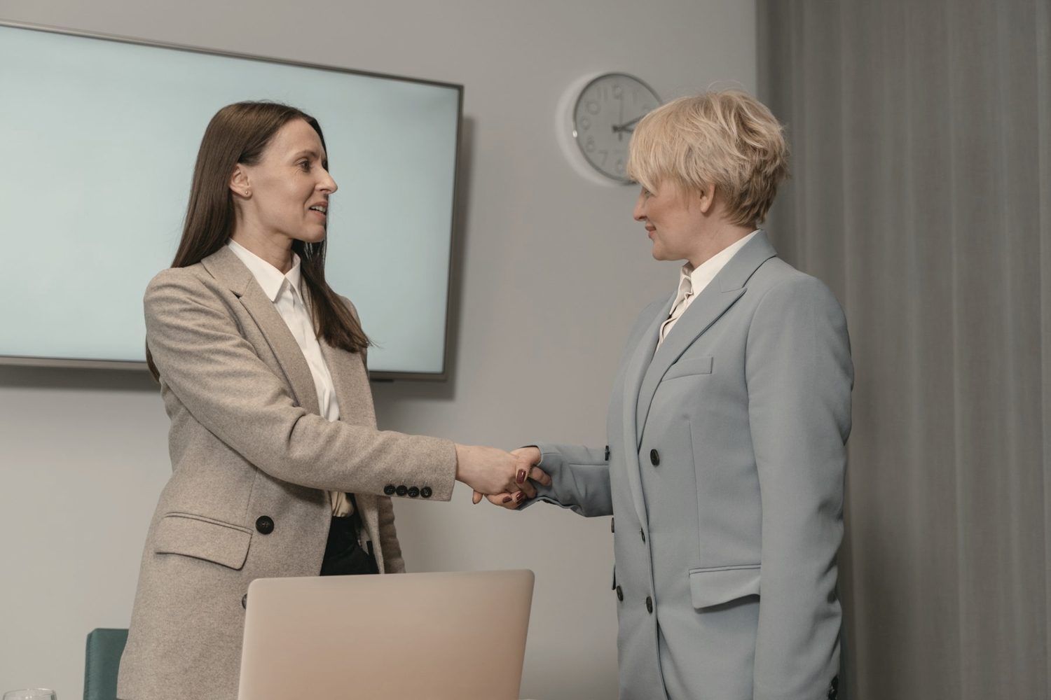 Two women greeting each other
