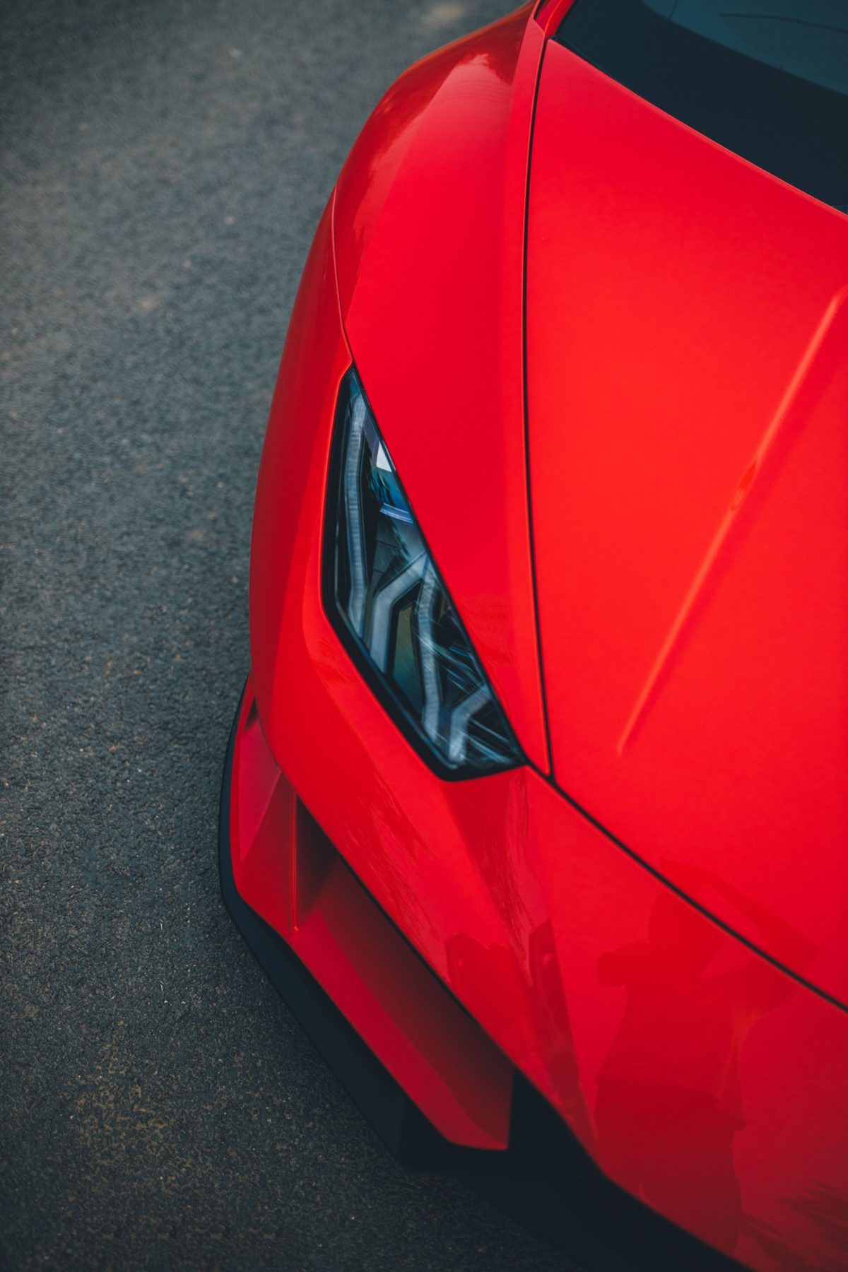 The bonnet of a red performance car seen from above