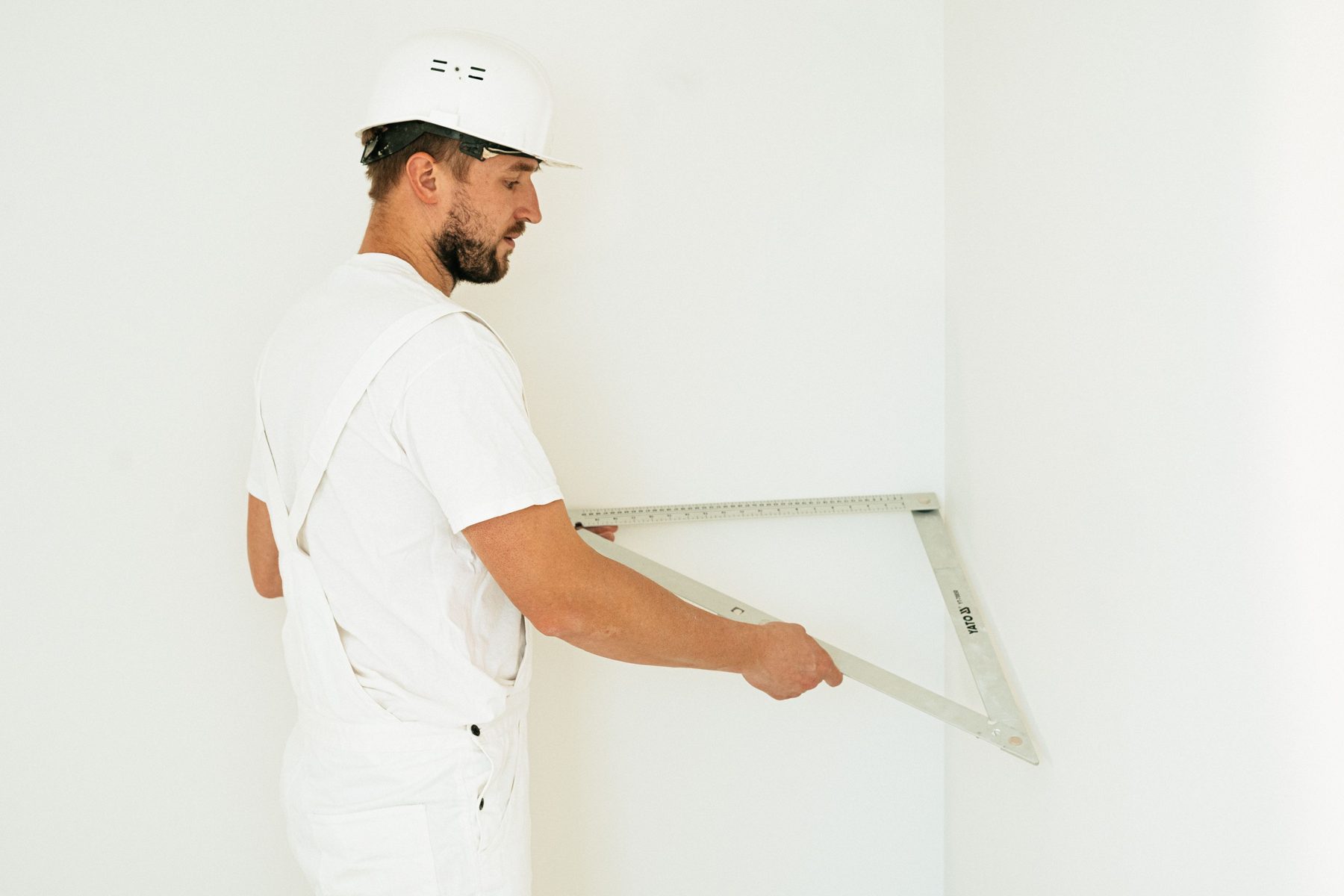 A tradesman checking a corner with a folding square