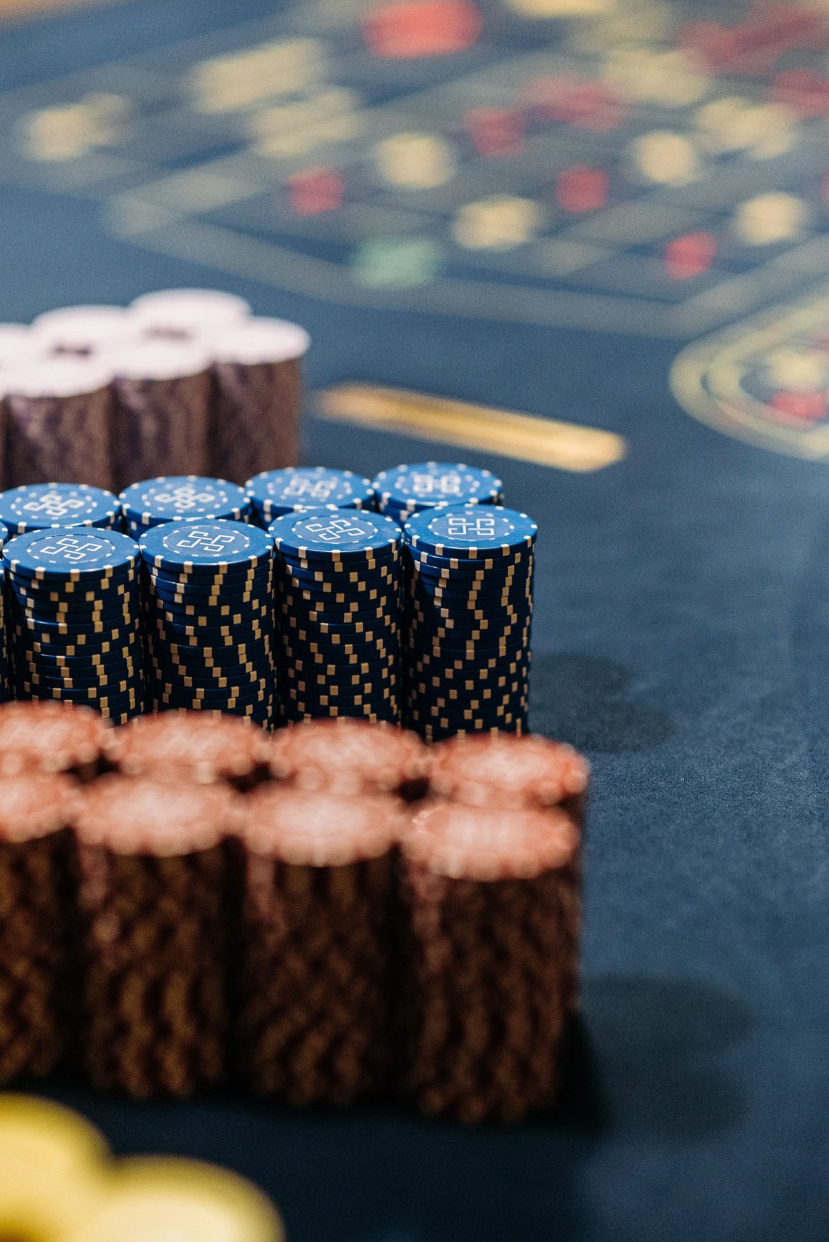 Tall stacks of blue chips on a gaming table