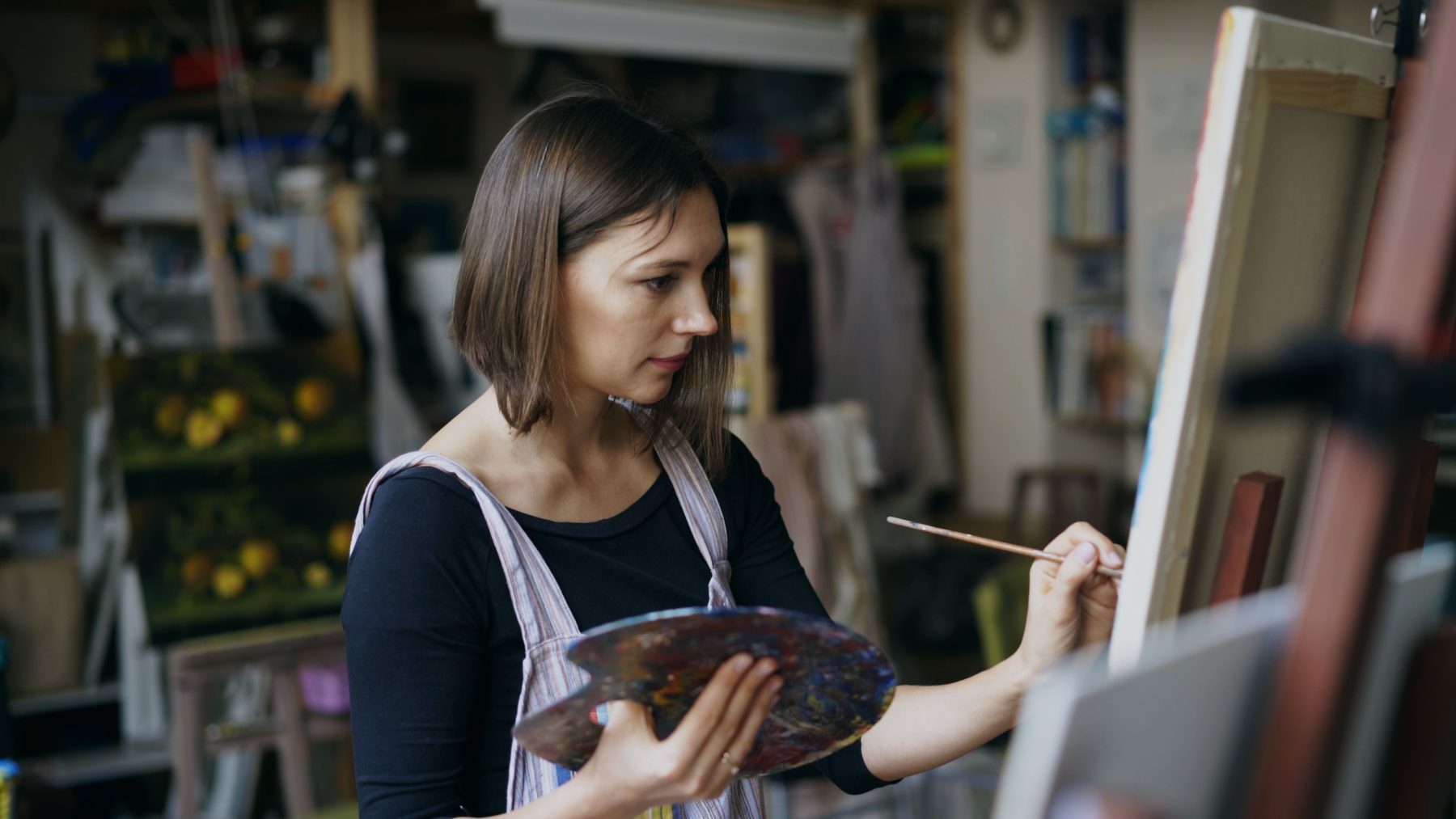 Maria Santos, practice manager, holding a palette