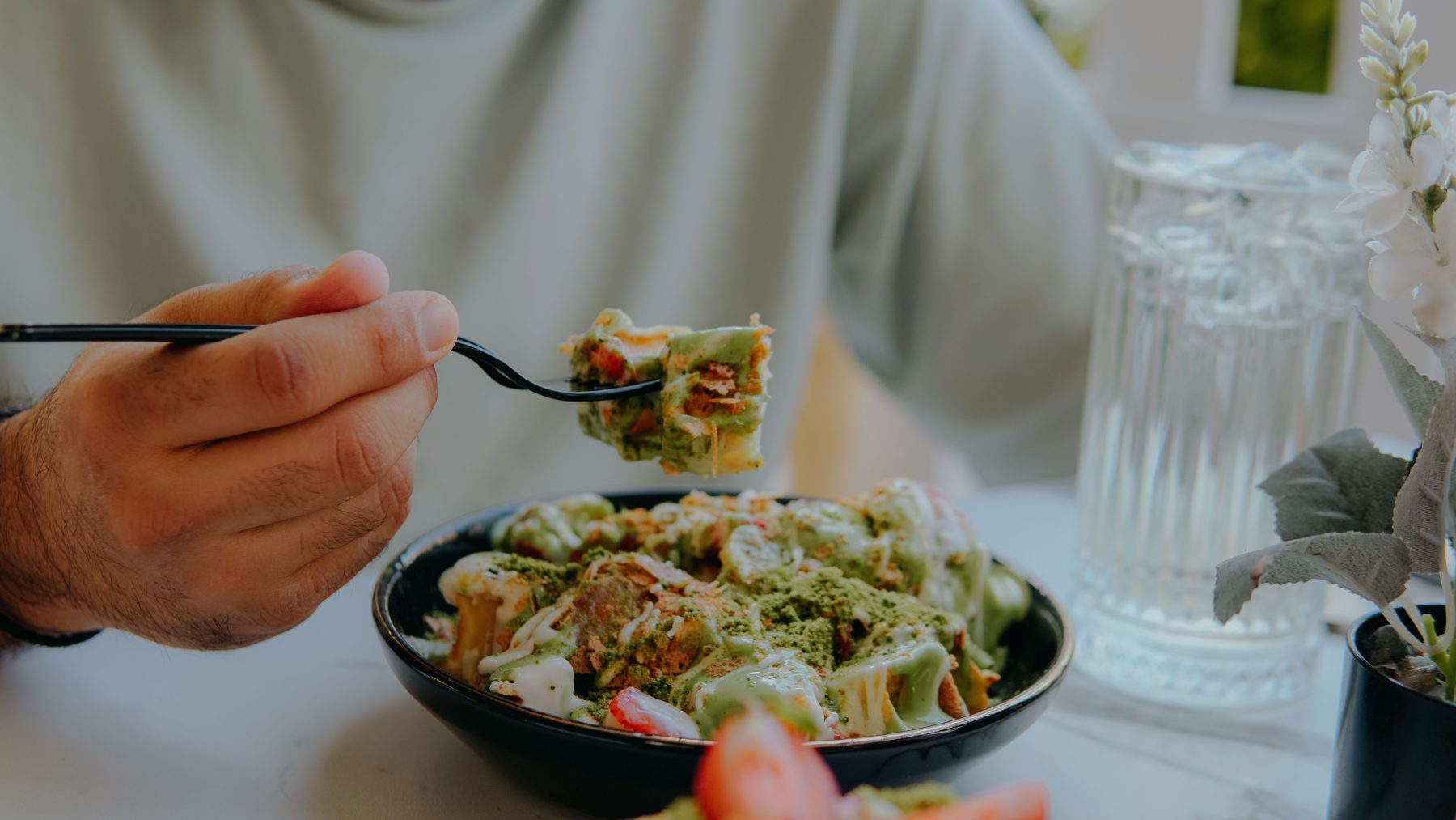 A fork lifting a healthy salad from a bowl