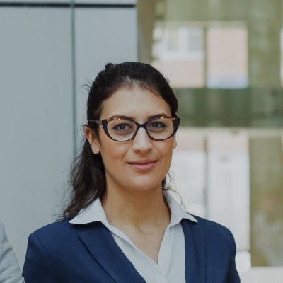 Priya, a smiling instructor with glasses